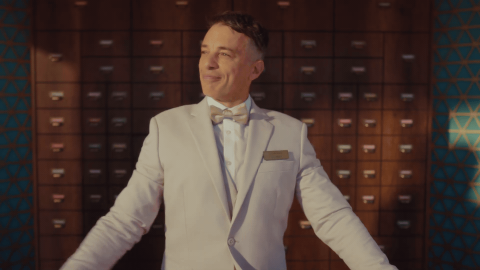 Lorenzo walks toward camera across Miami Beach in the opening of the film